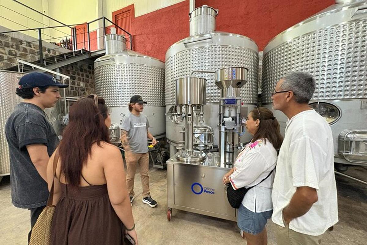 a group of people standing around in a brewery