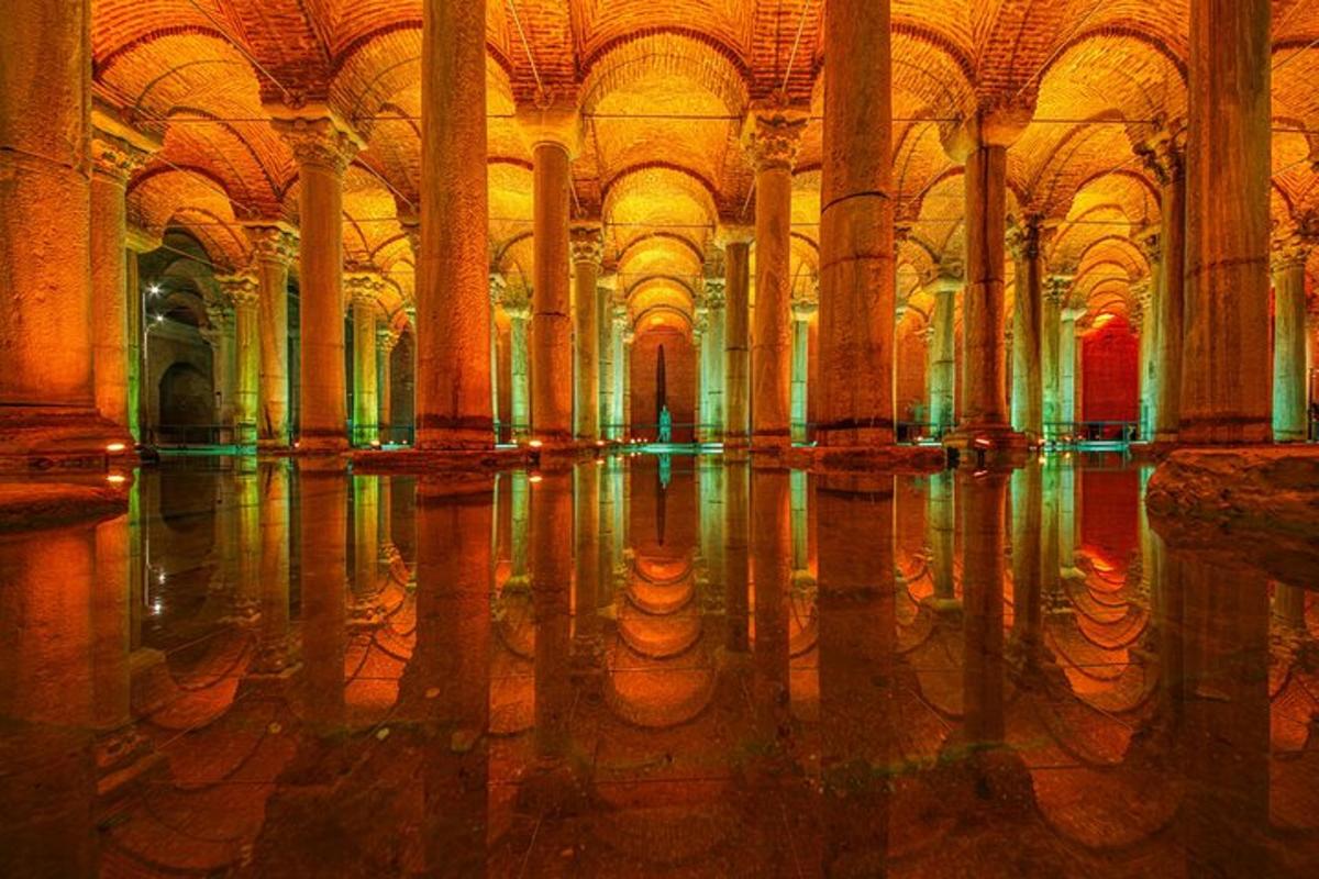 a large room with columns and reflections in the water