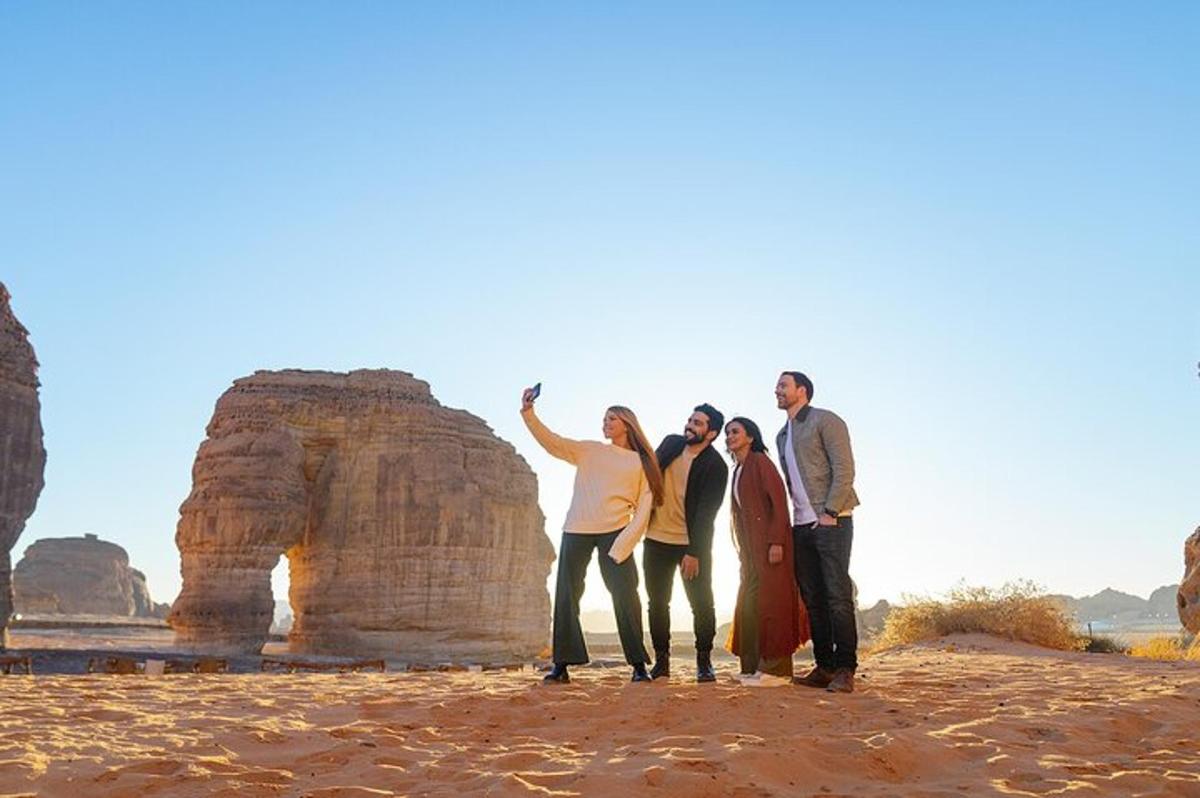 a group of people standing in front of some rocks