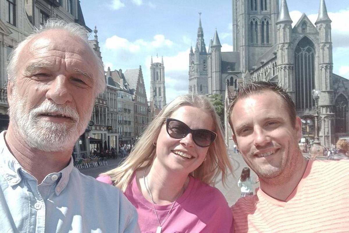 two men and a woman standing in front of a cathedral