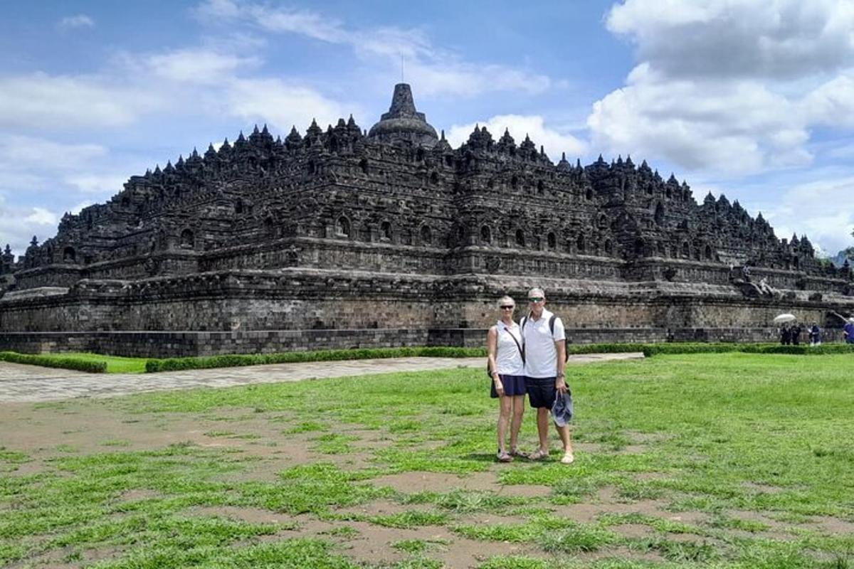 a man and woman standing in front of a large building