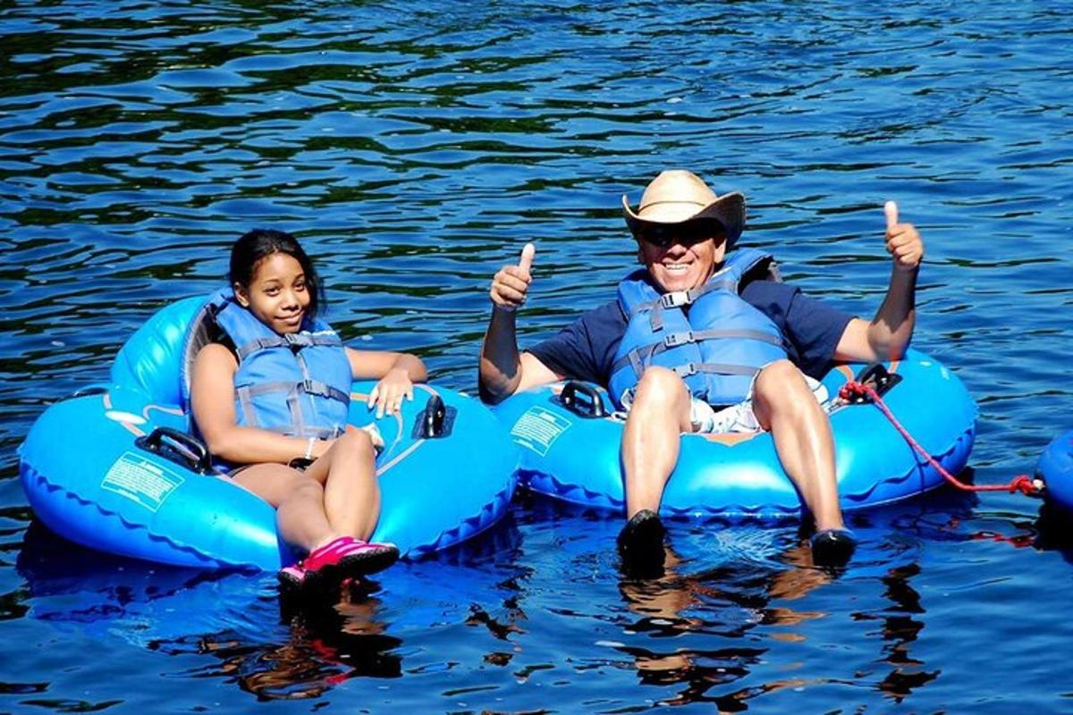 a man and a woman sitting on a raft in the water