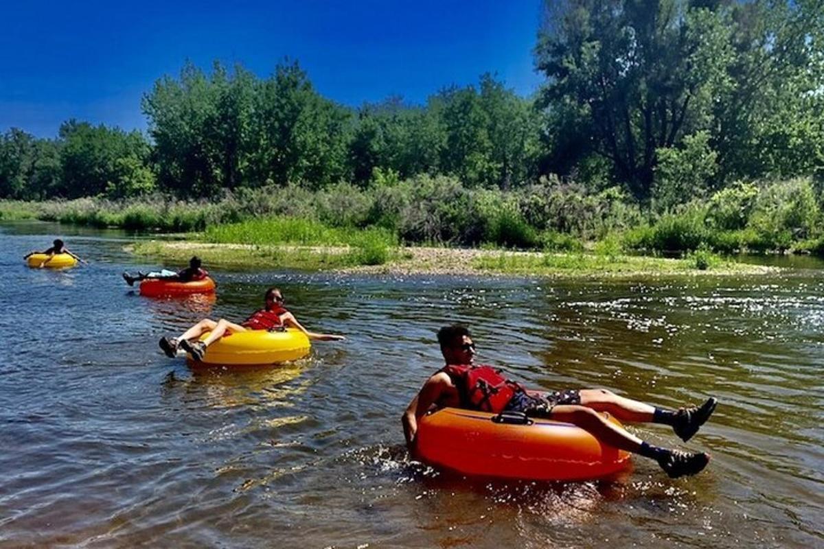 a group of people riding in rafts on a river
