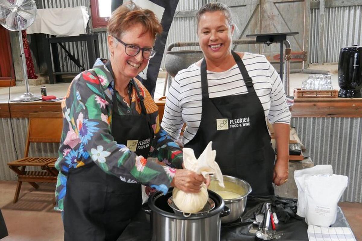 two people standing in a kitchen preparing food
