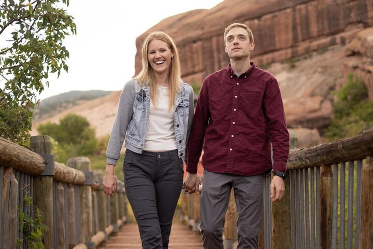 a man and a woman walking down a bridge