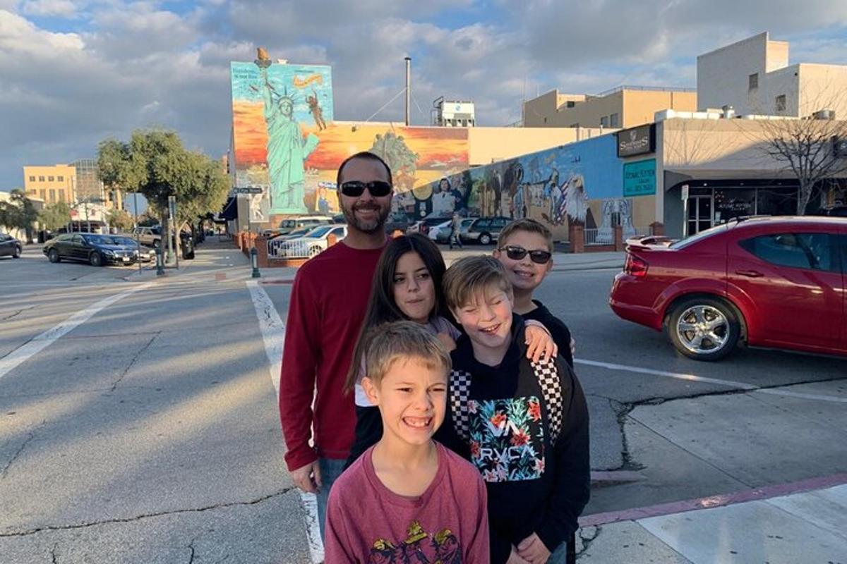 a family posing for a picture on the street