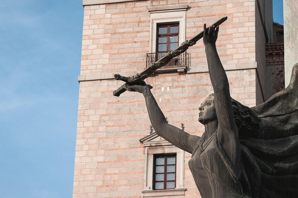a statue of a woman holding a gun in front of a building