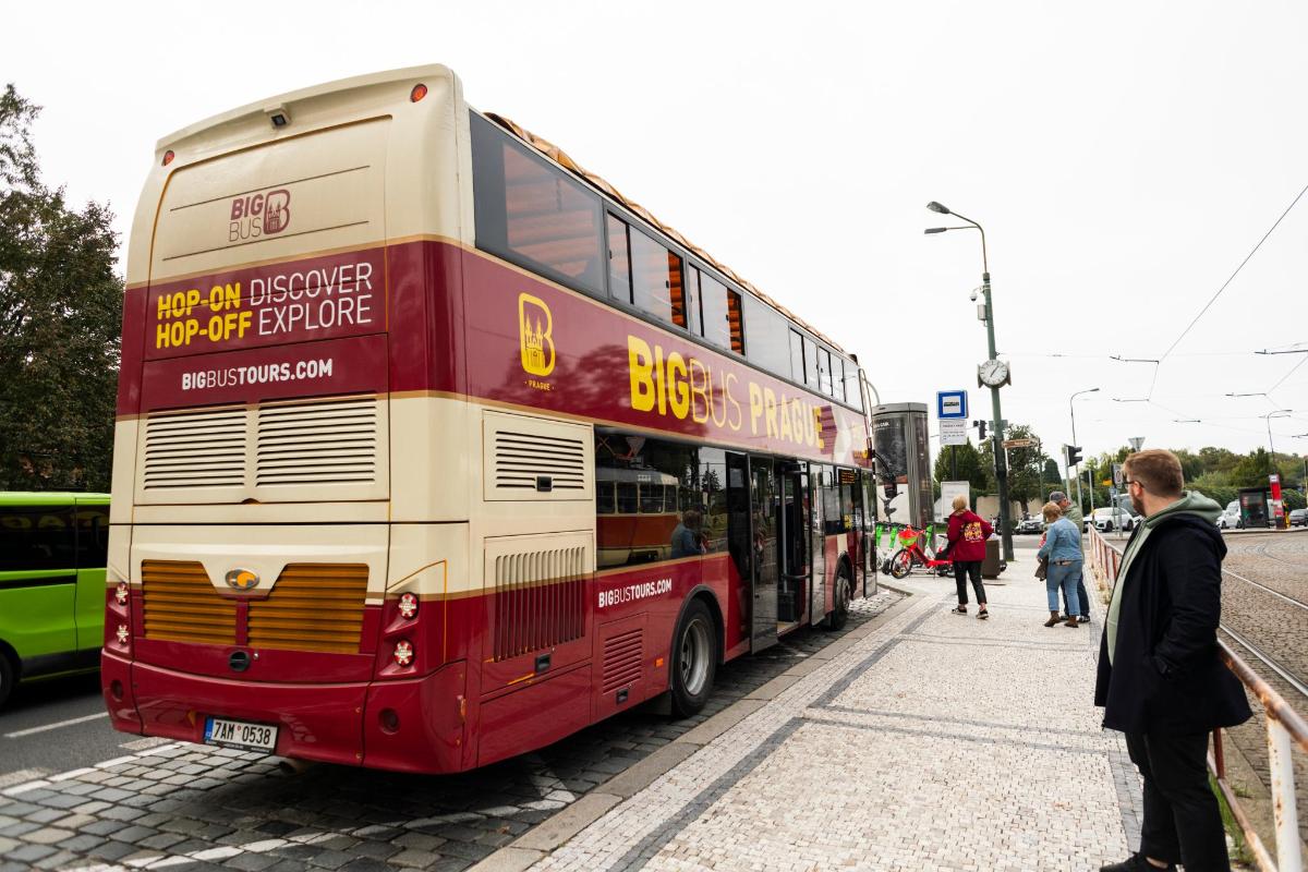 a red double decker bus parked on a street