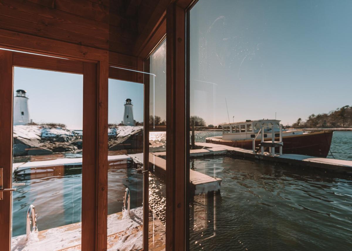 a reflection of a lighthouse in the windows of a boat