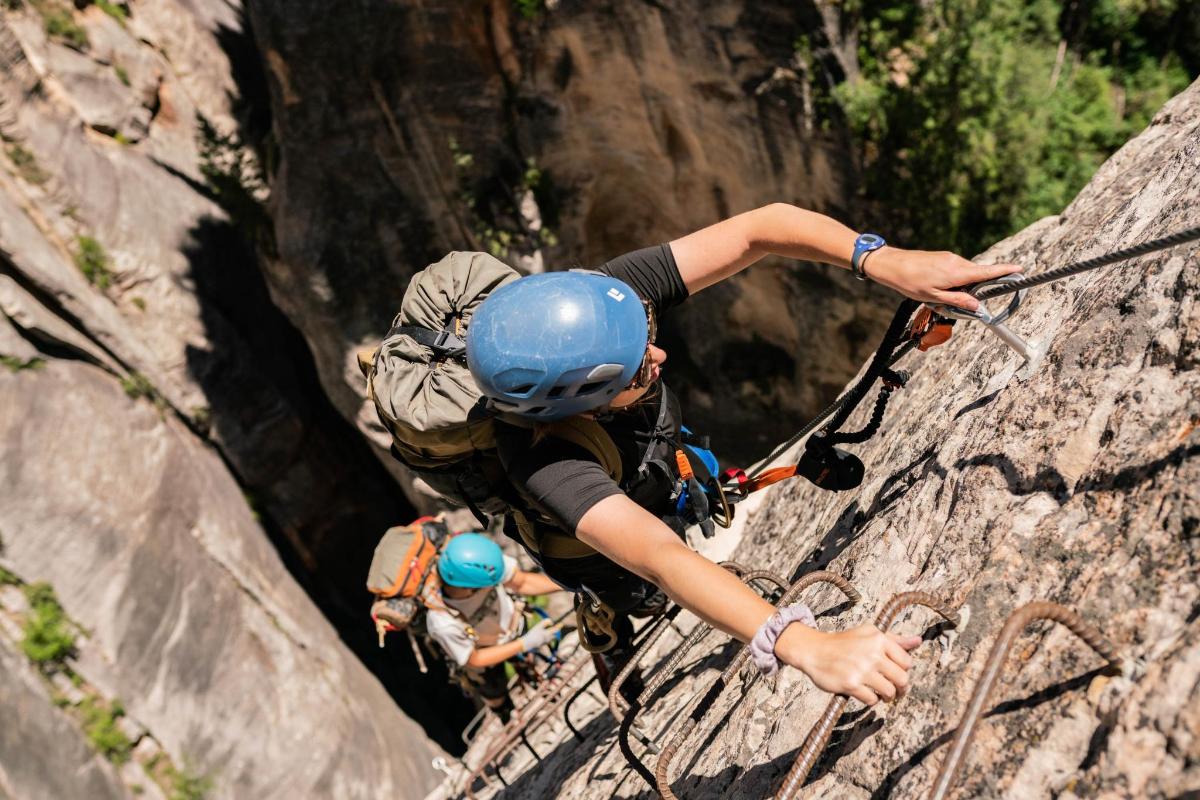 a group of people climbing on a rock wall
