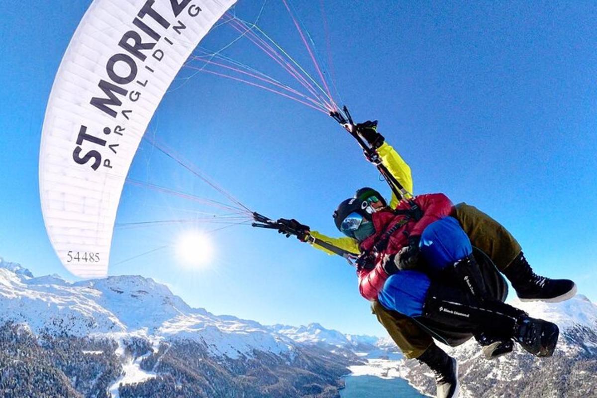 a person in the air with a parachute