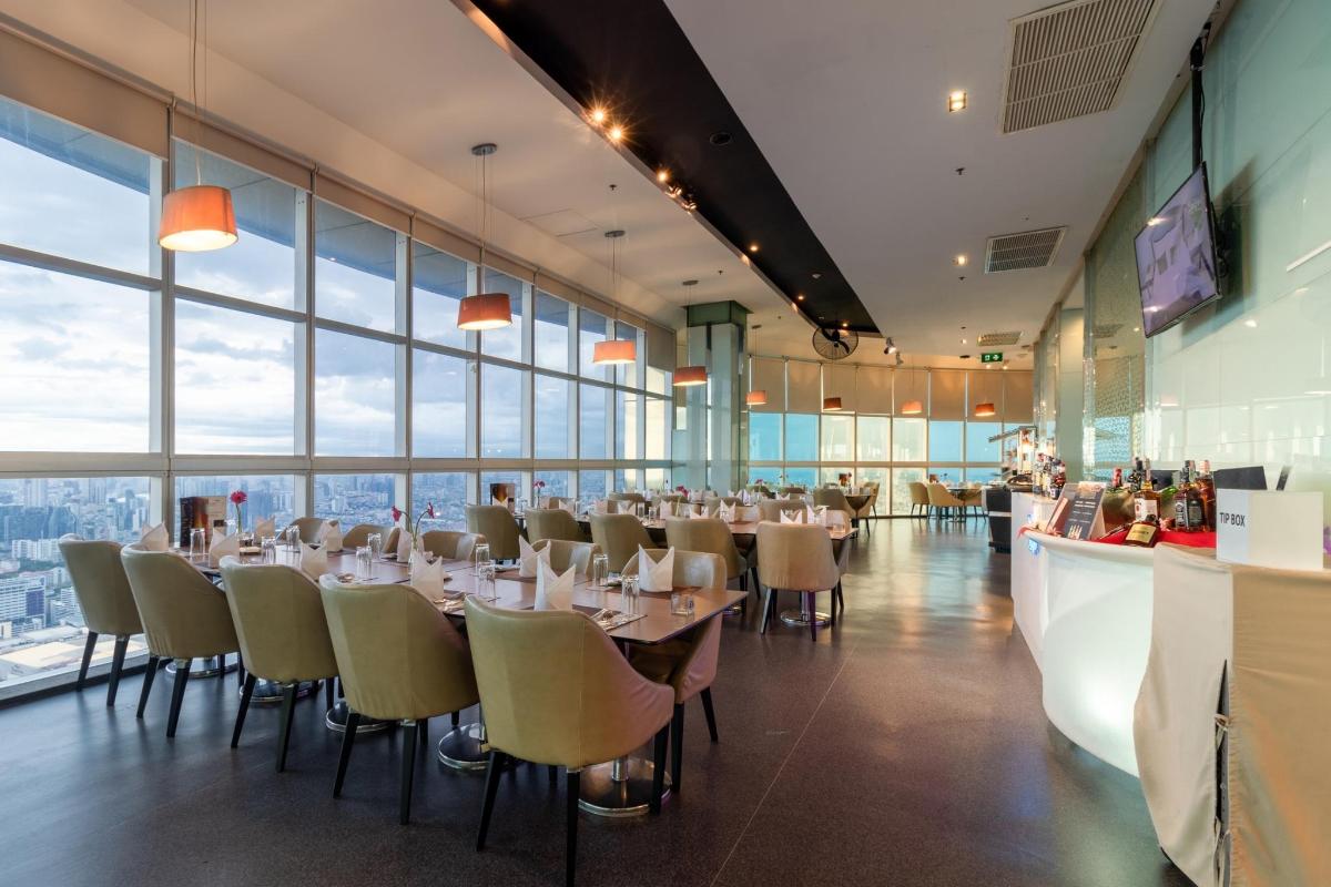 a dining room with tables and chairs and windows