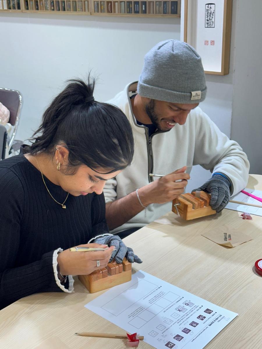 a man and a woman playing with wooden blocks
