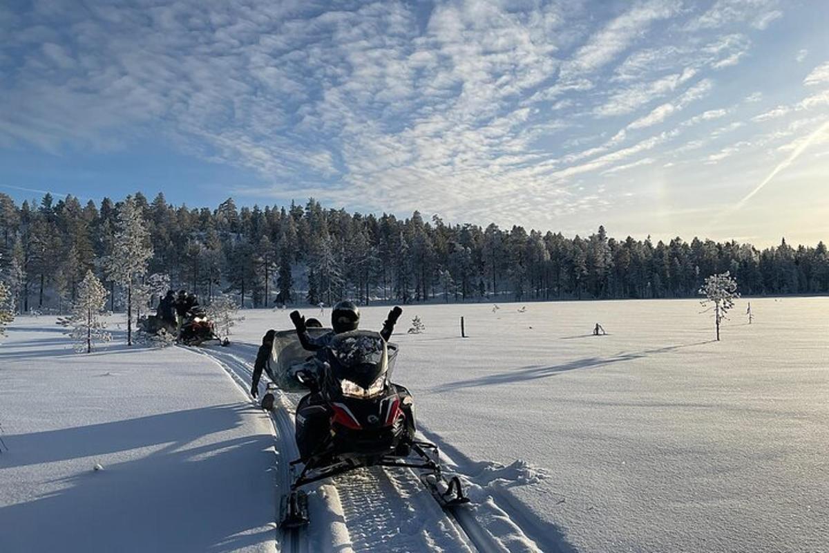 a snowmobile is driving through a snow covered field