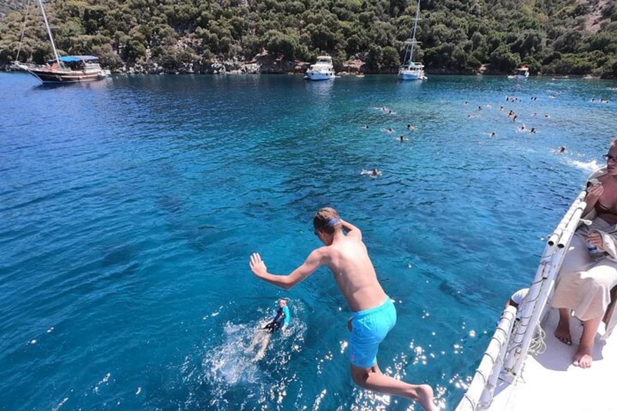 a man in the water with a dolphin in the water