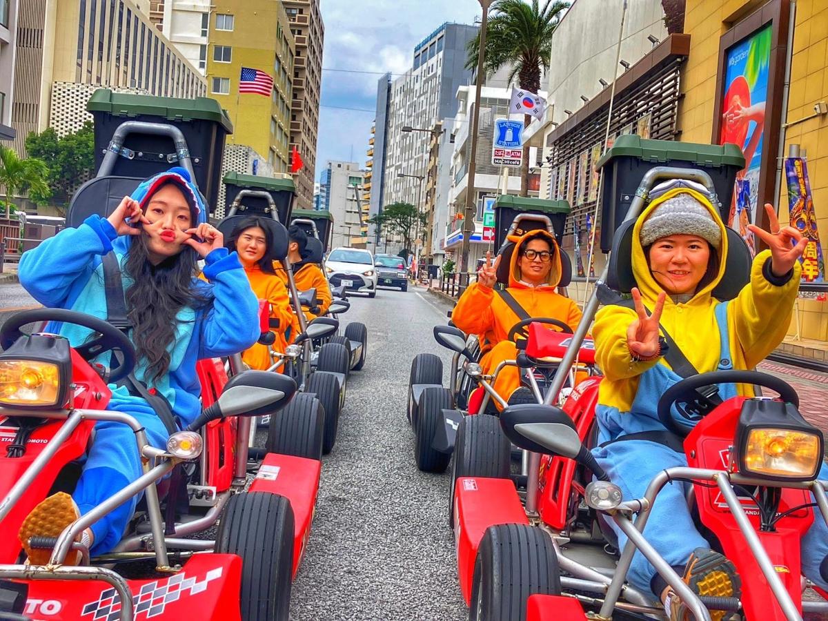 a group of people riding down a city street on a group of cars