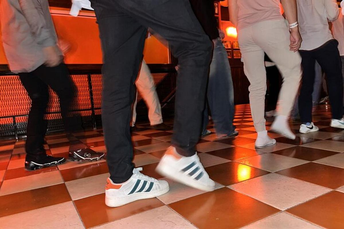 a group of people dancing on a dance floor