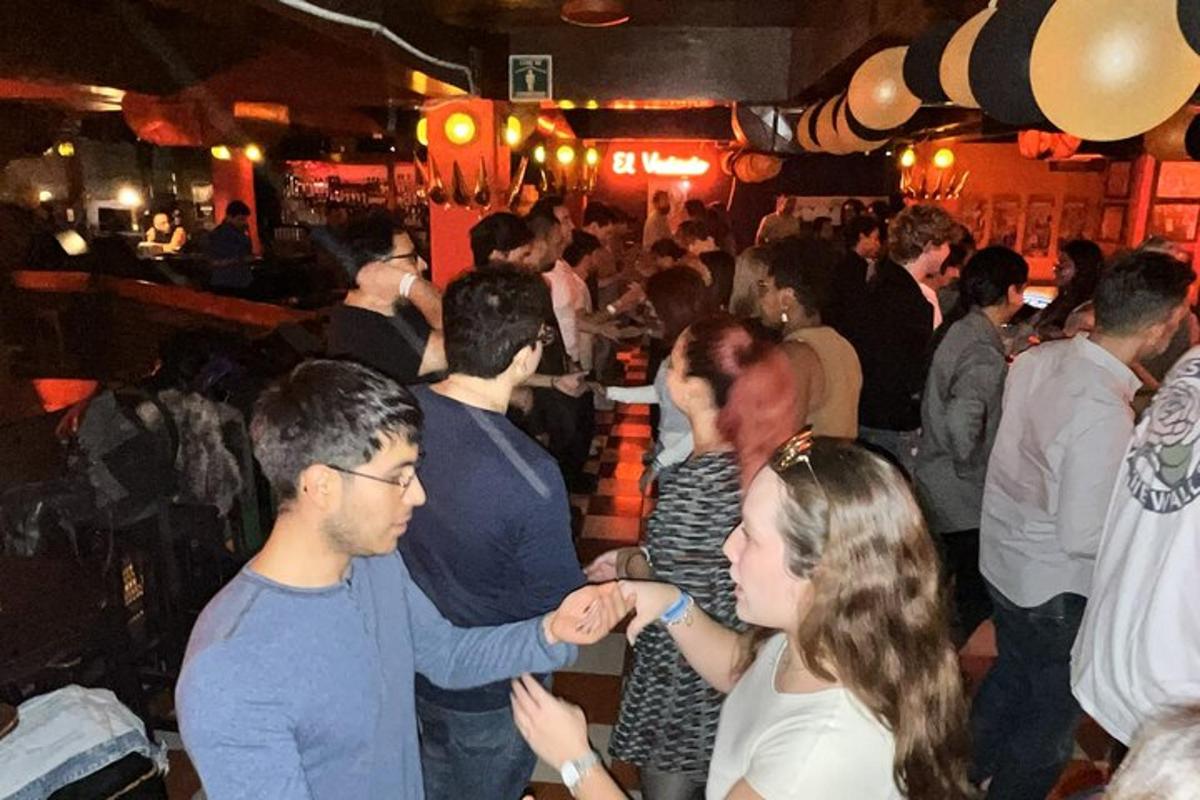 a group of people standing in a crowd in a bar