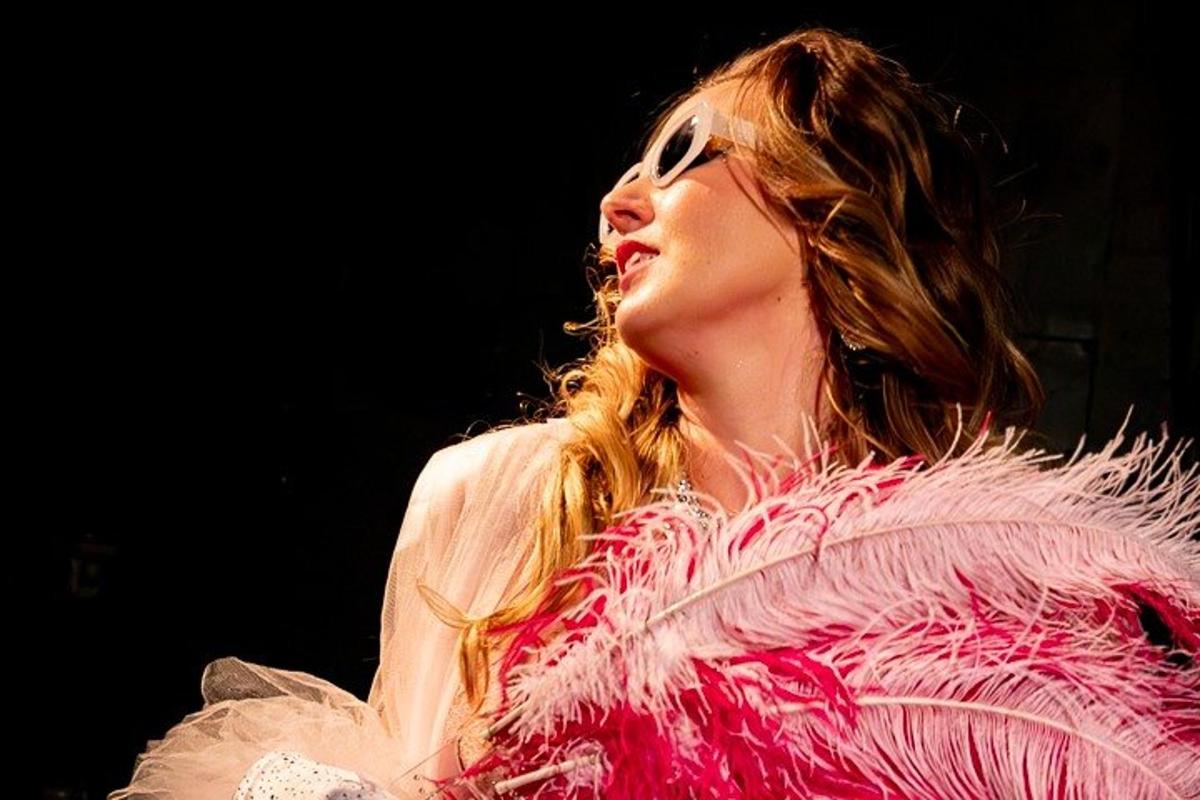 a woman in a pink dress on a stage