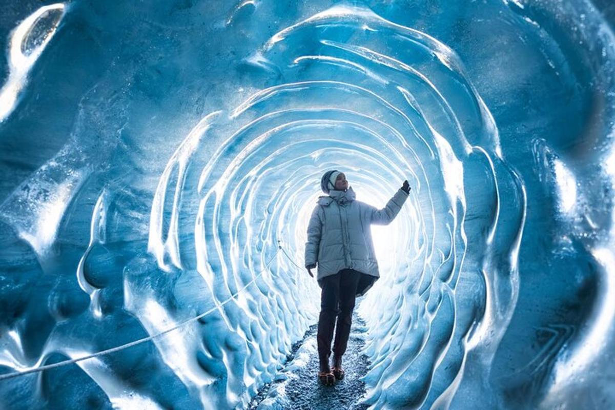 a person walking through an ice tunnel