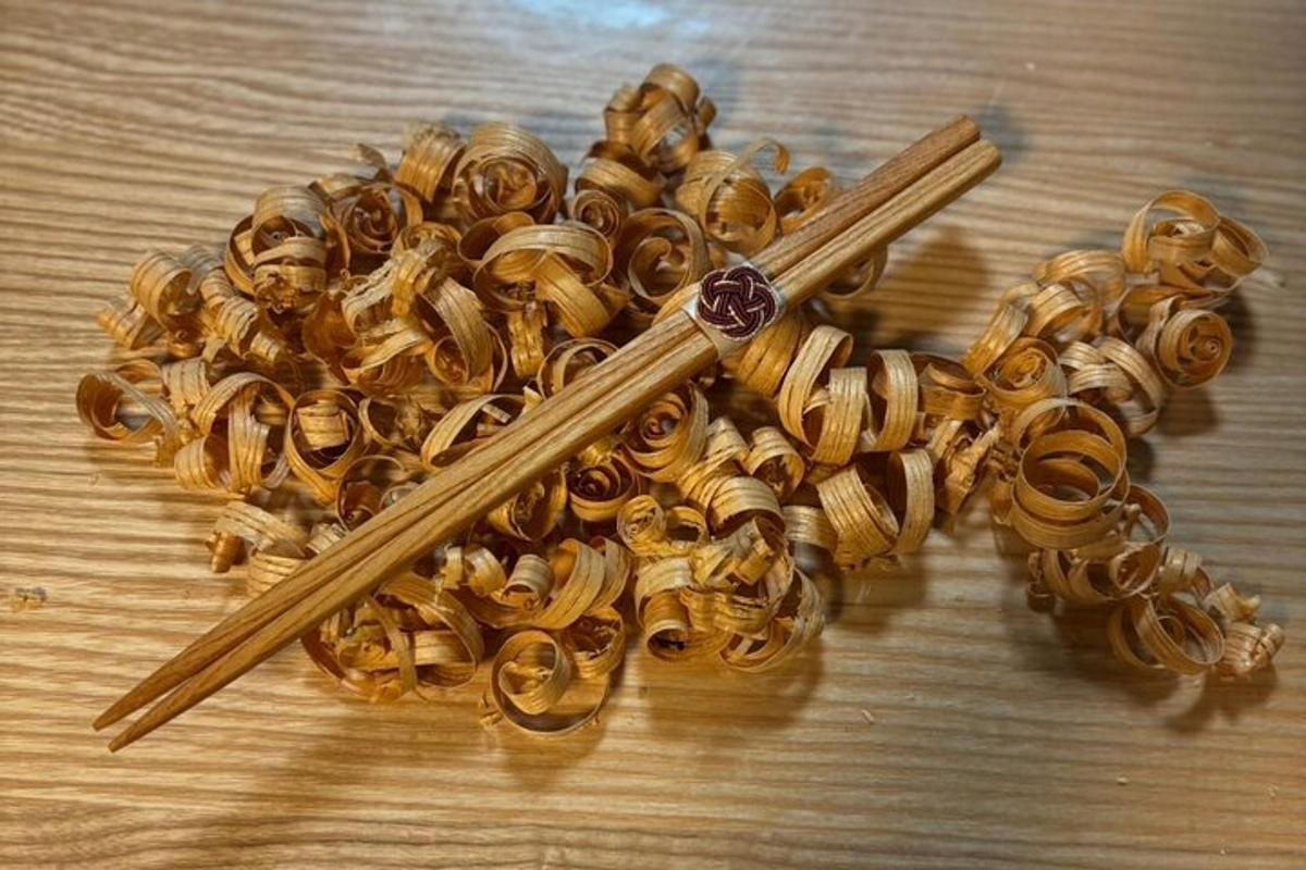 a pile of gold pins with a pair of chopsticks