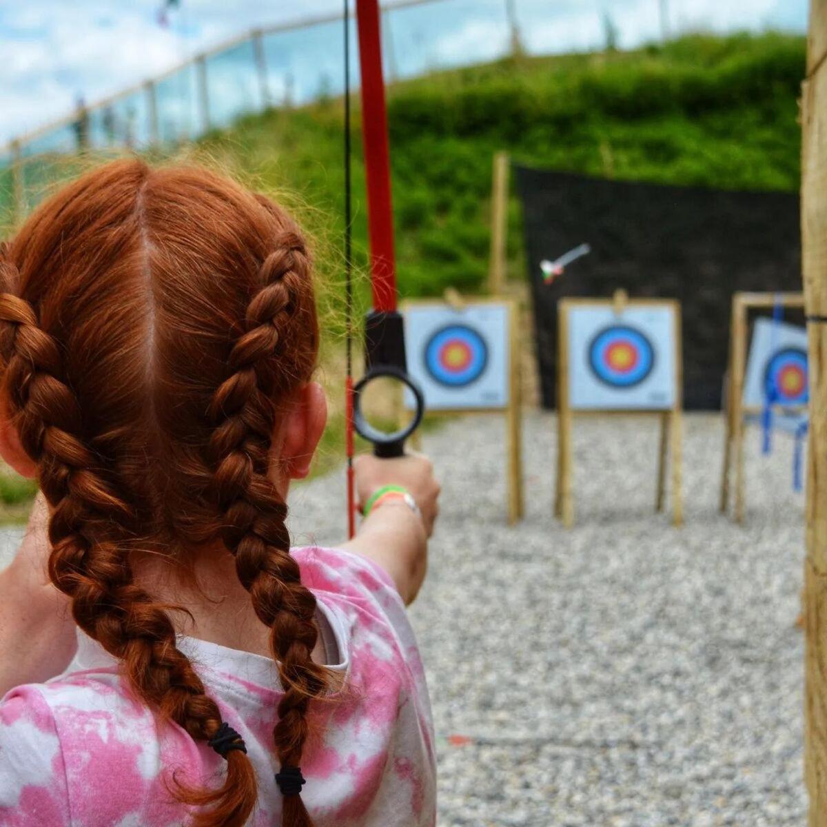 a little girl is playing with a target