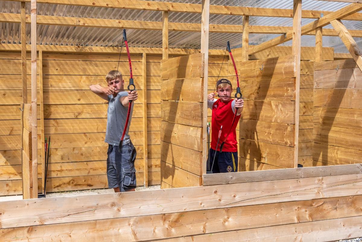 two men on the wall of a wooden building