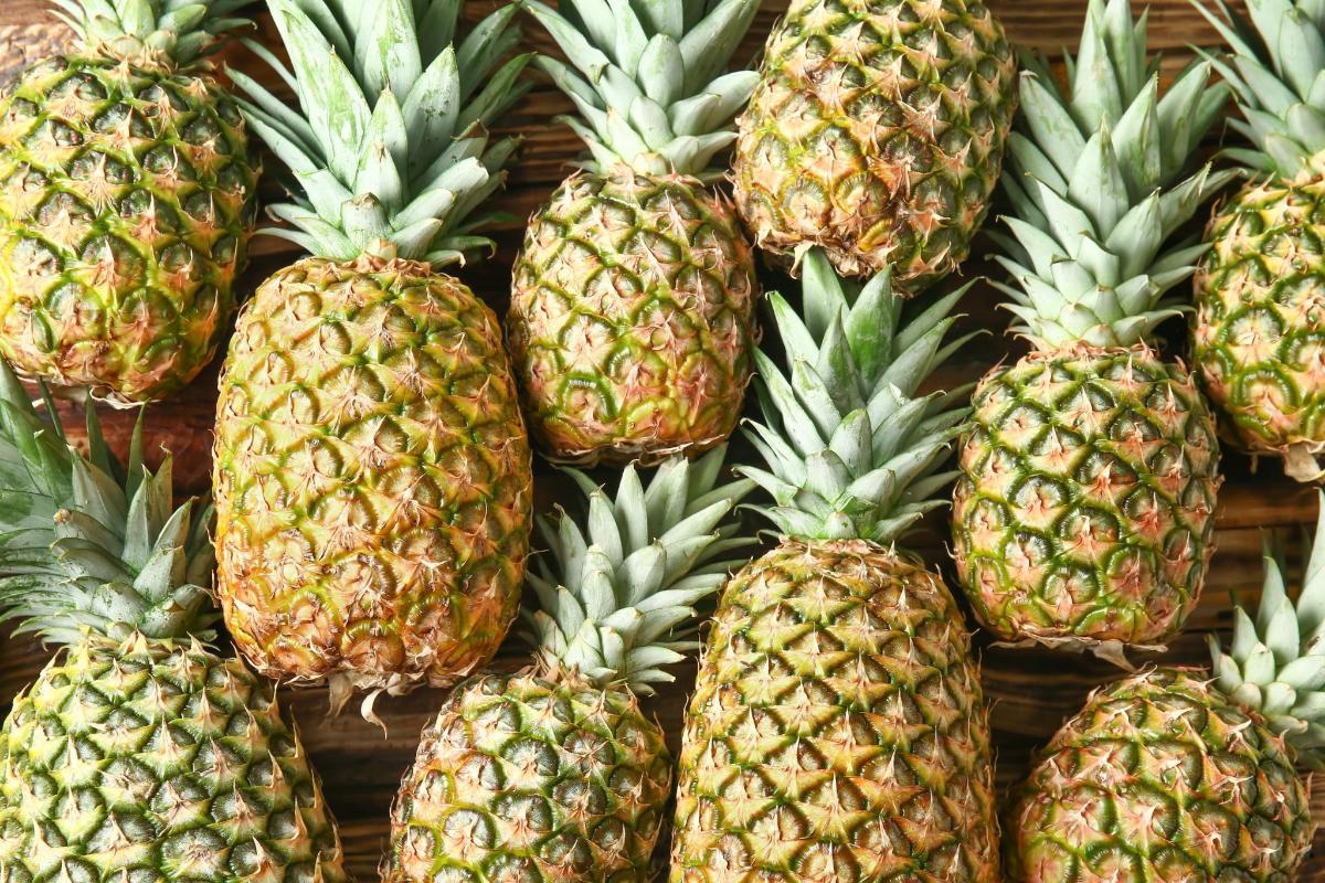 a pile of pineapples on display in a store
