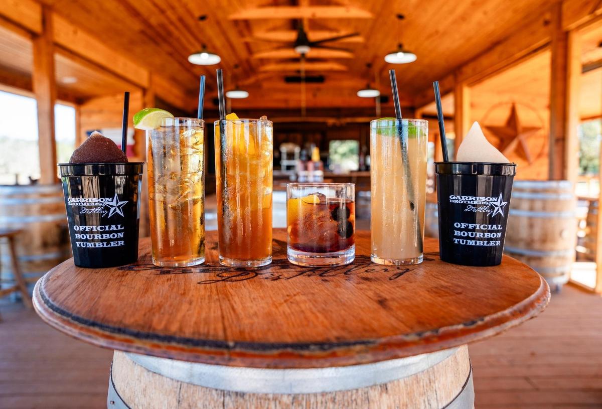 a wooden table with four glasses on top of it