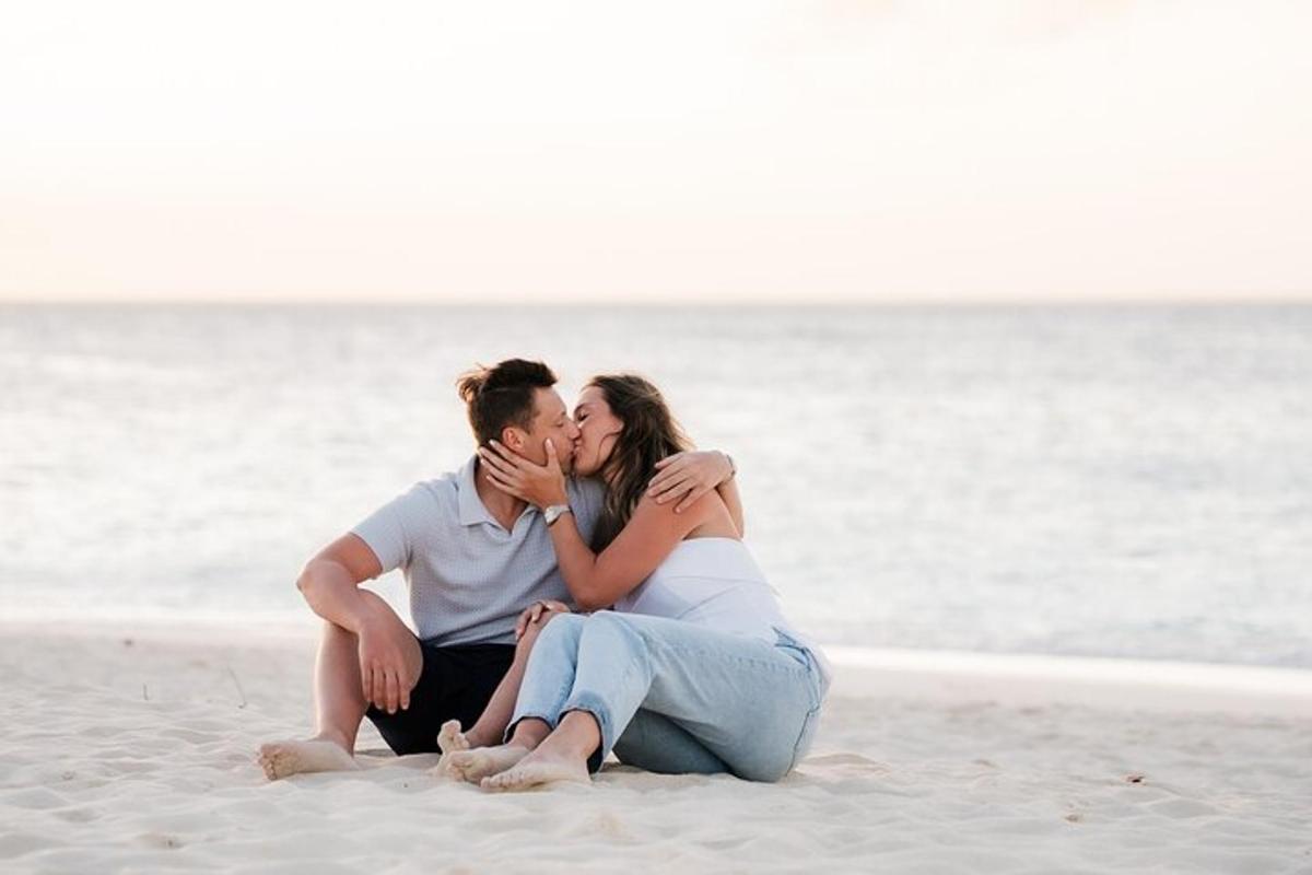 a man and a woman sitting on the beach