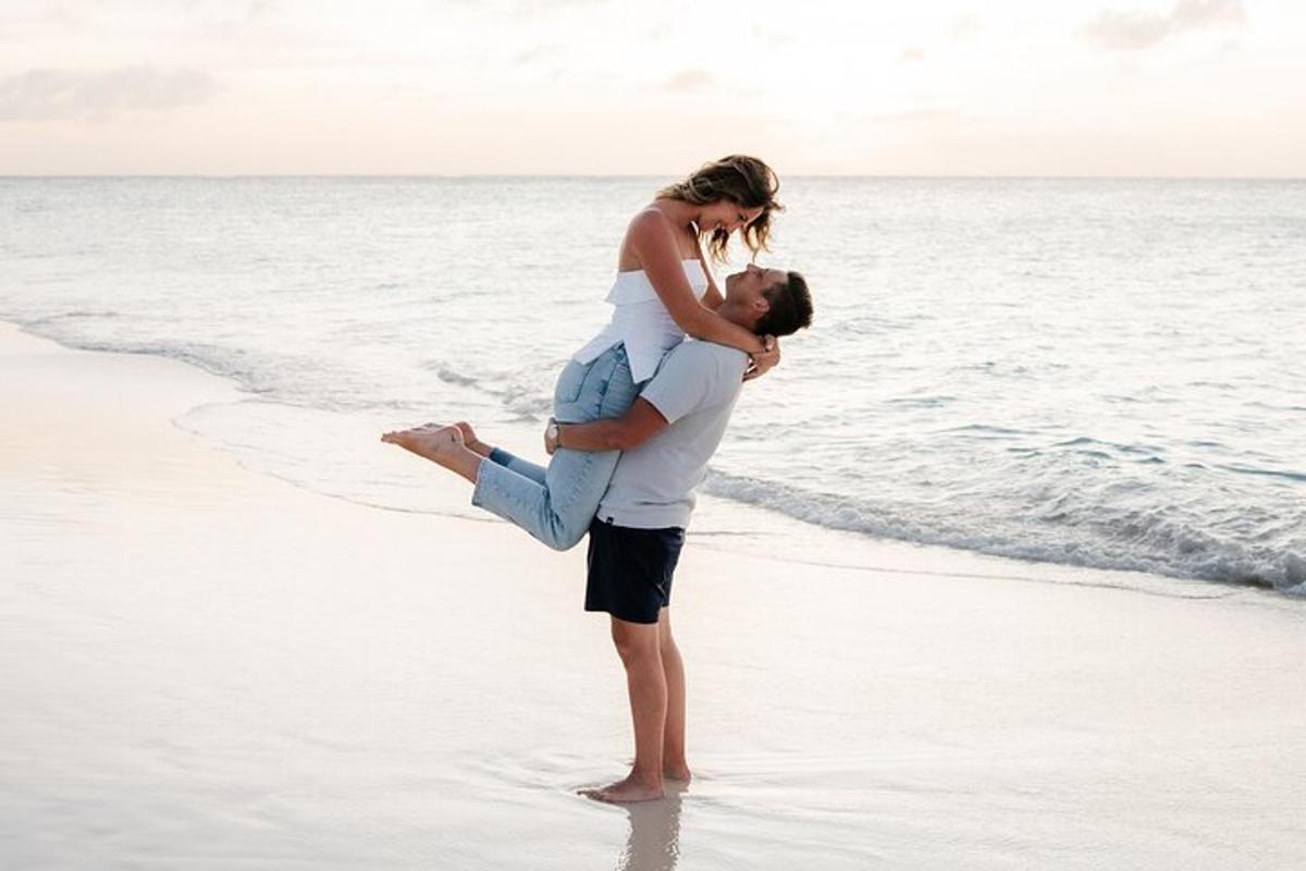 a man carrying a woman on the beach