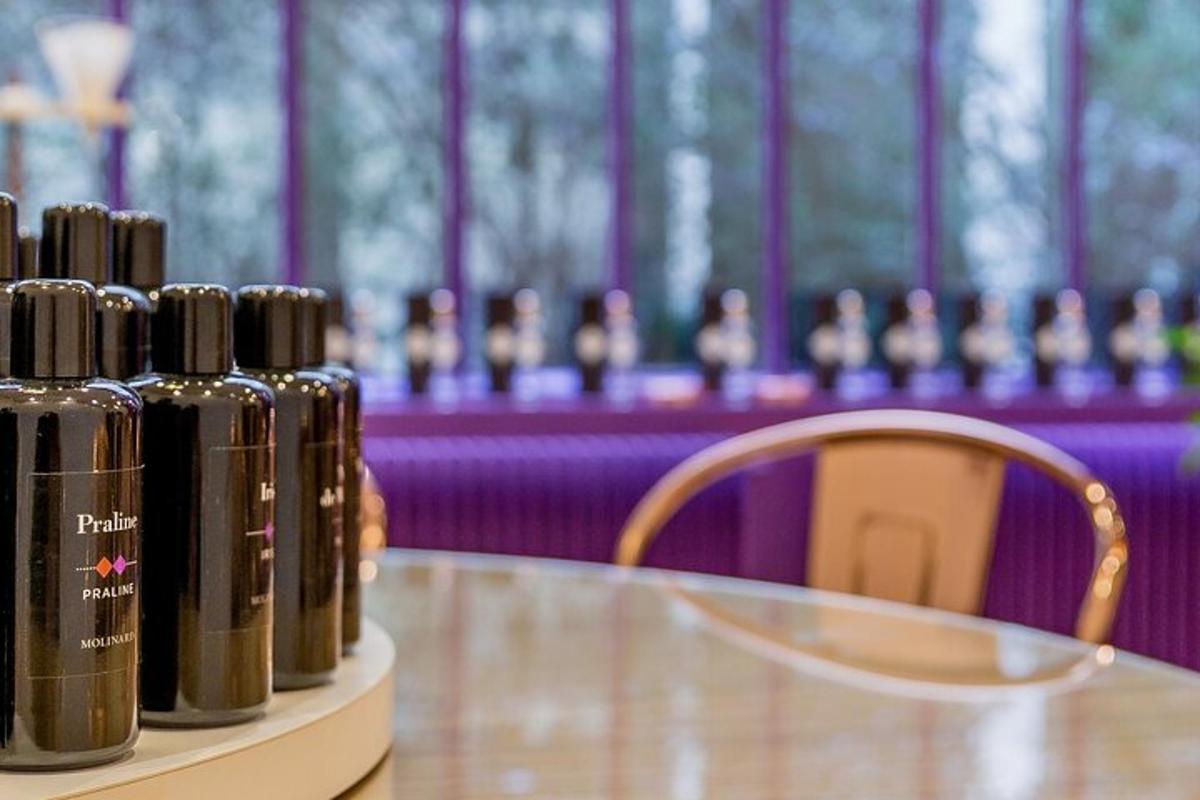 four bottles of wine sitting on a table next to a chair