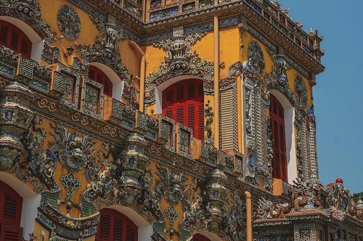 an ornate building with red shutters on it