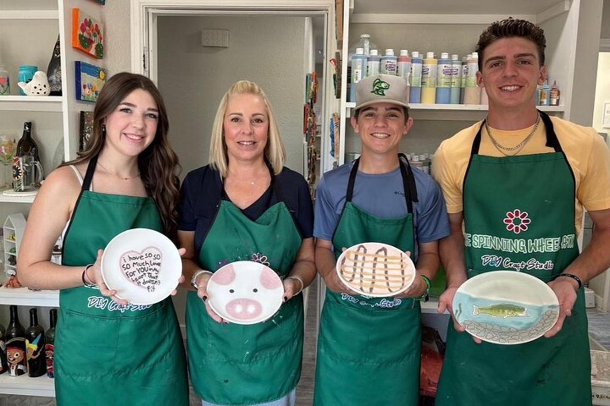a group of three people holding plates in a store