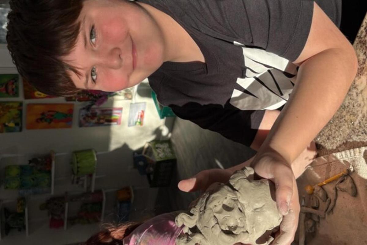 a woman is holding a skull in her hand
