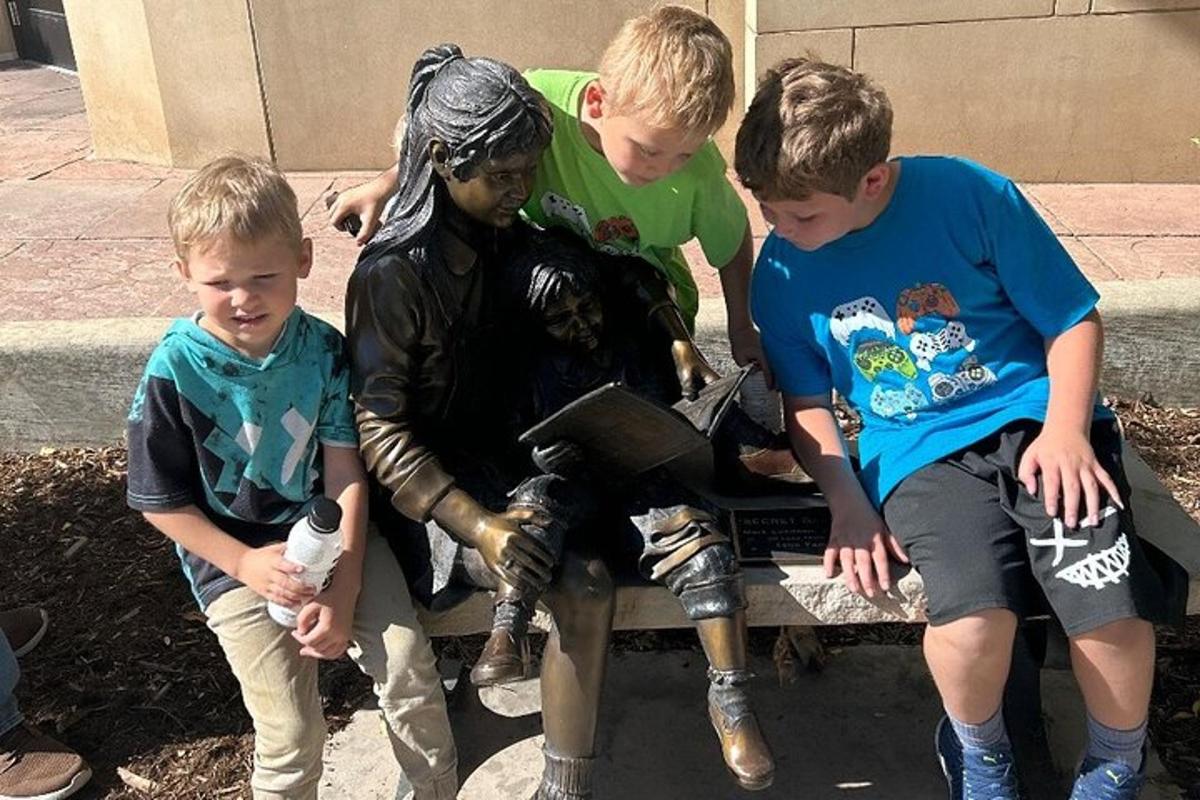 a group of young boys sitting on a bench