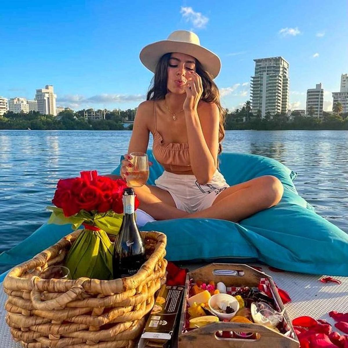 a woman sitting on a raft with a glass of wine