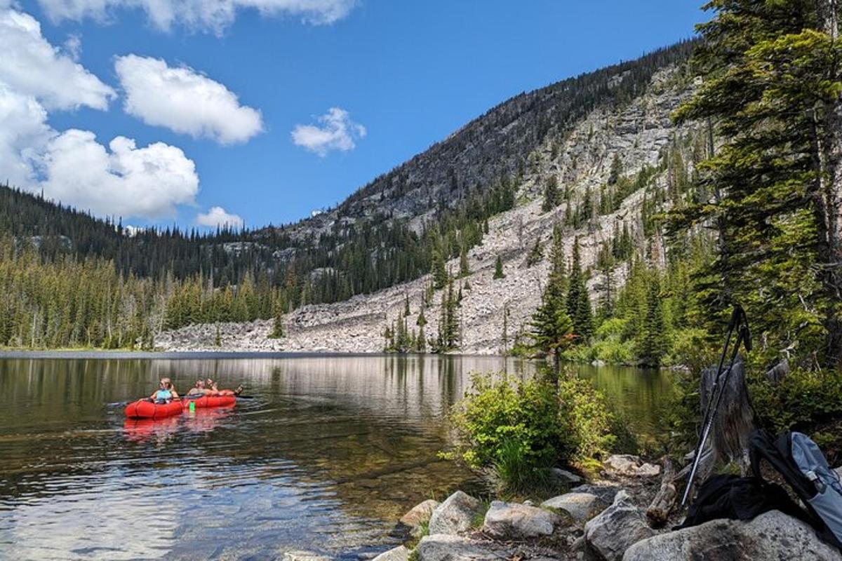 two people in a red kayak on a lake