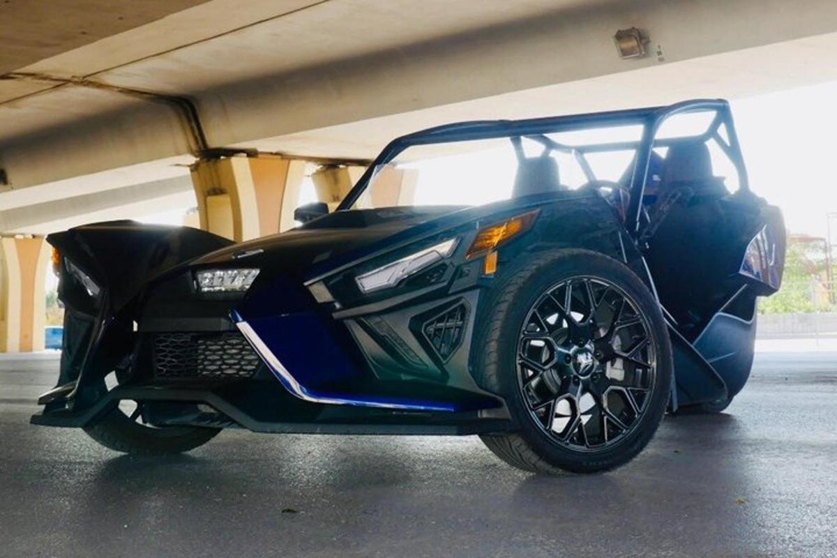 a black car parked in a parking garage