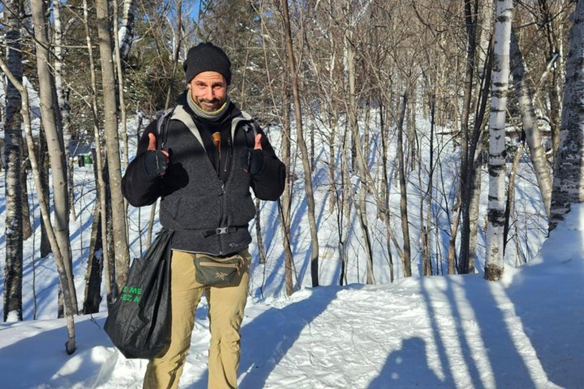 a man giving the thumbs up while walking in the snow