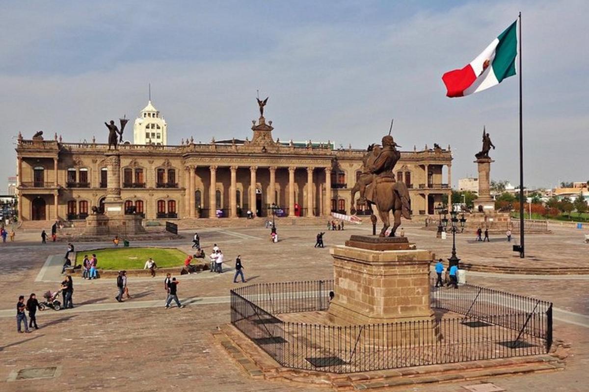 a statue in front of a building with a flag