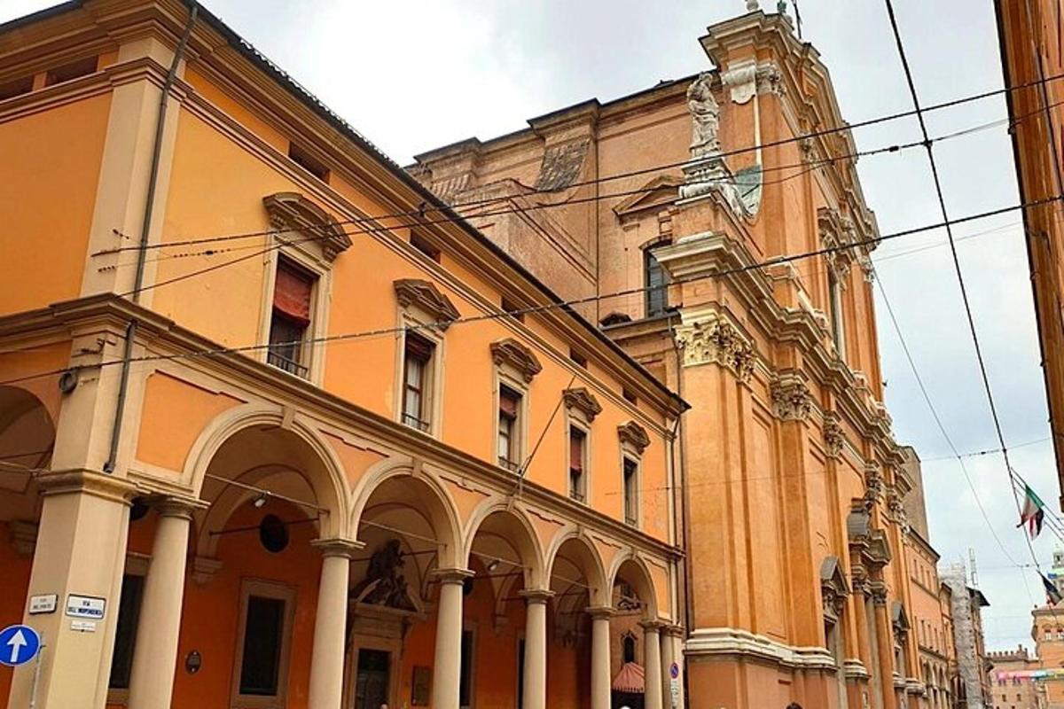 an orange building with a clock tower on a street