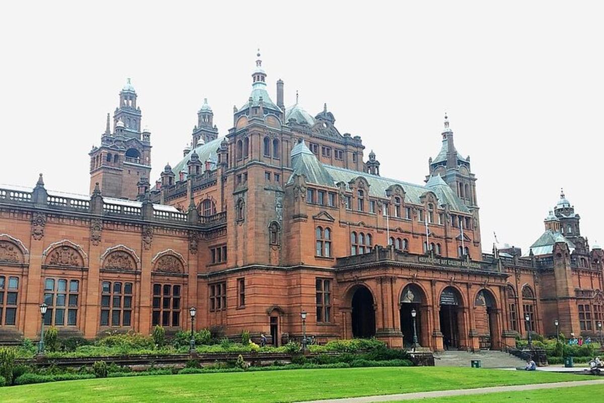 a large brick building with a green lawn in front