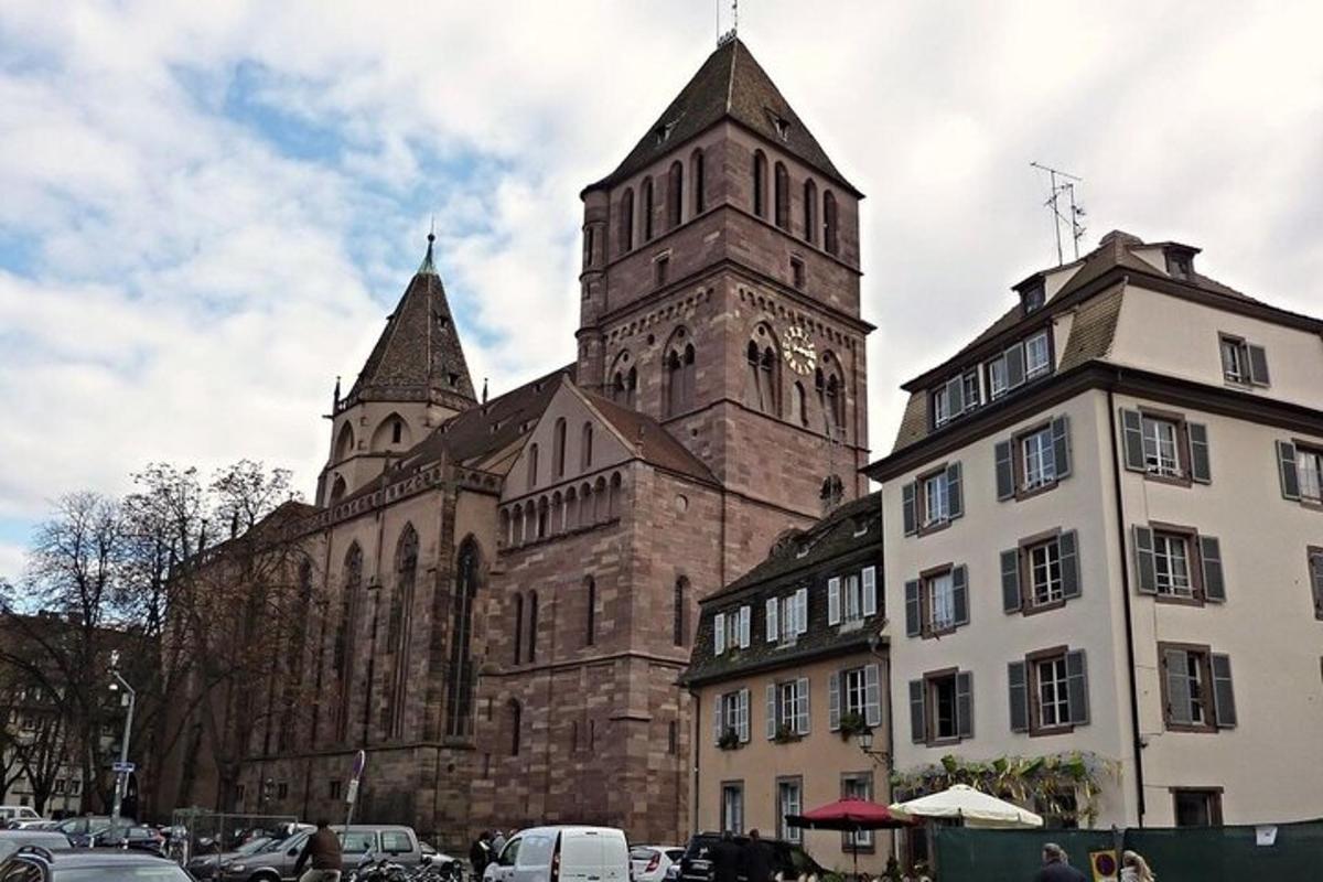 an old church with a clock tower next to a building