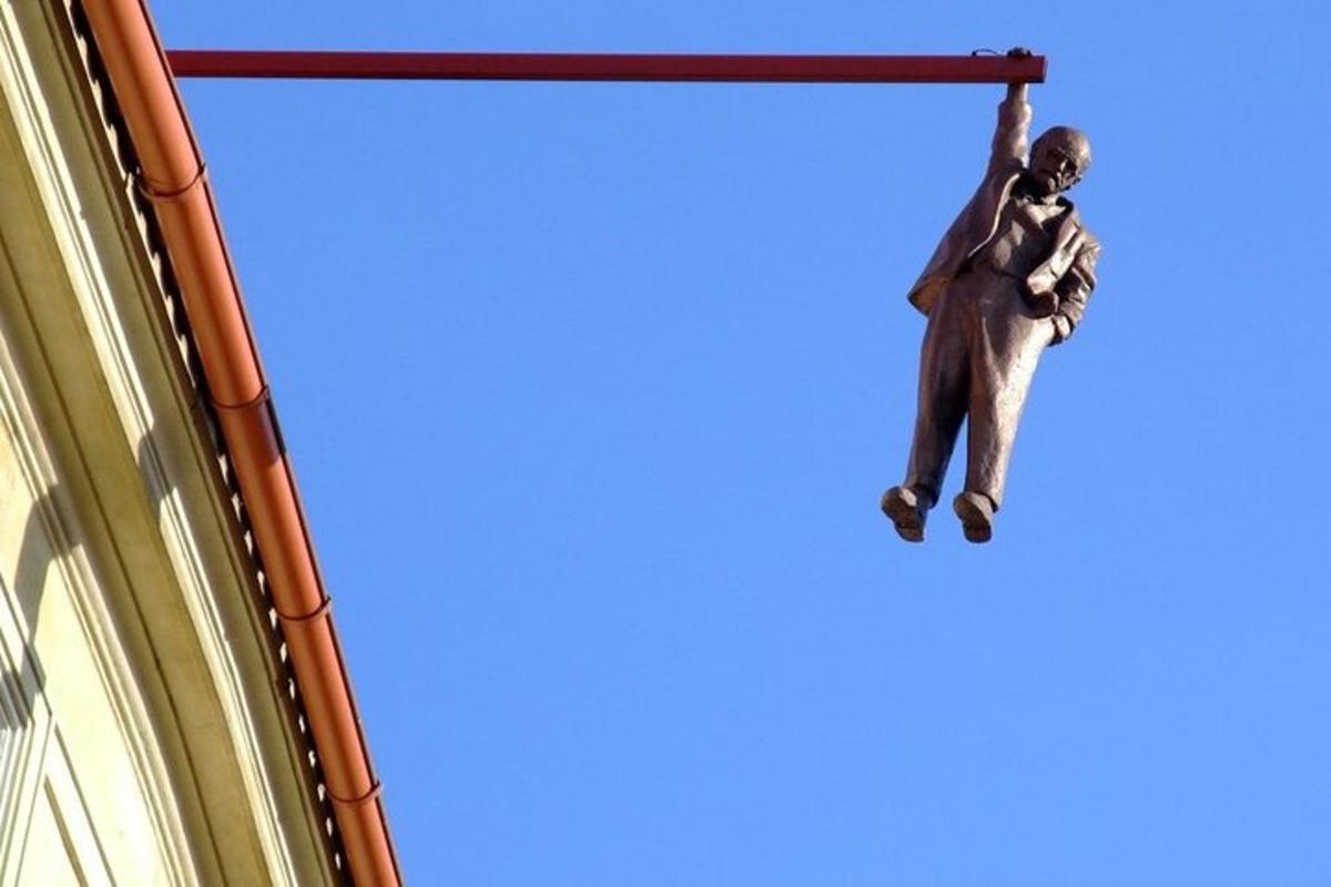 a monkey hanging from a pole on a building