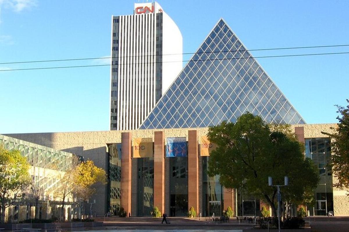 a large building with a tall skyscraper in the background