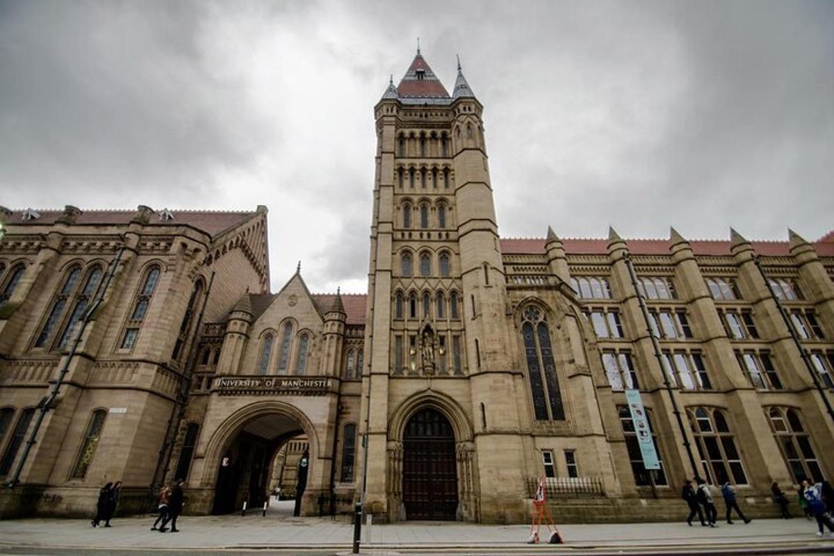 a large building with a clock tower in front of it