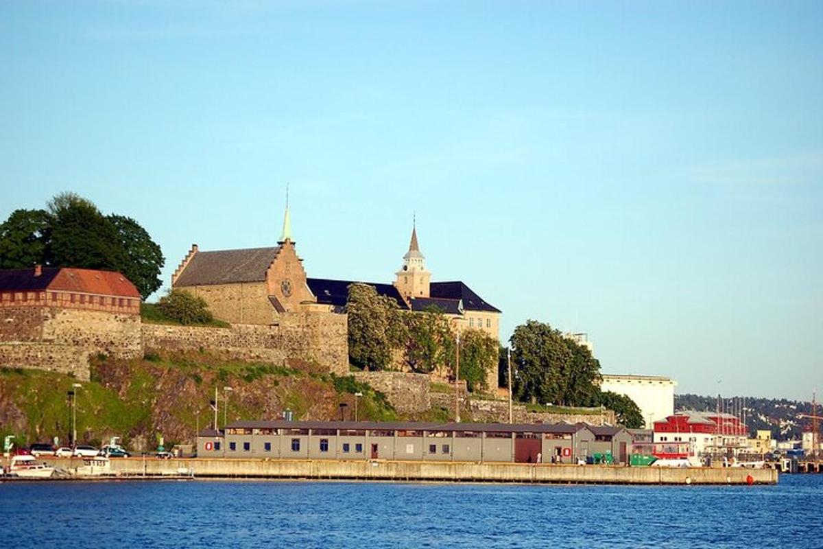 a castle on top of a hill next to the water