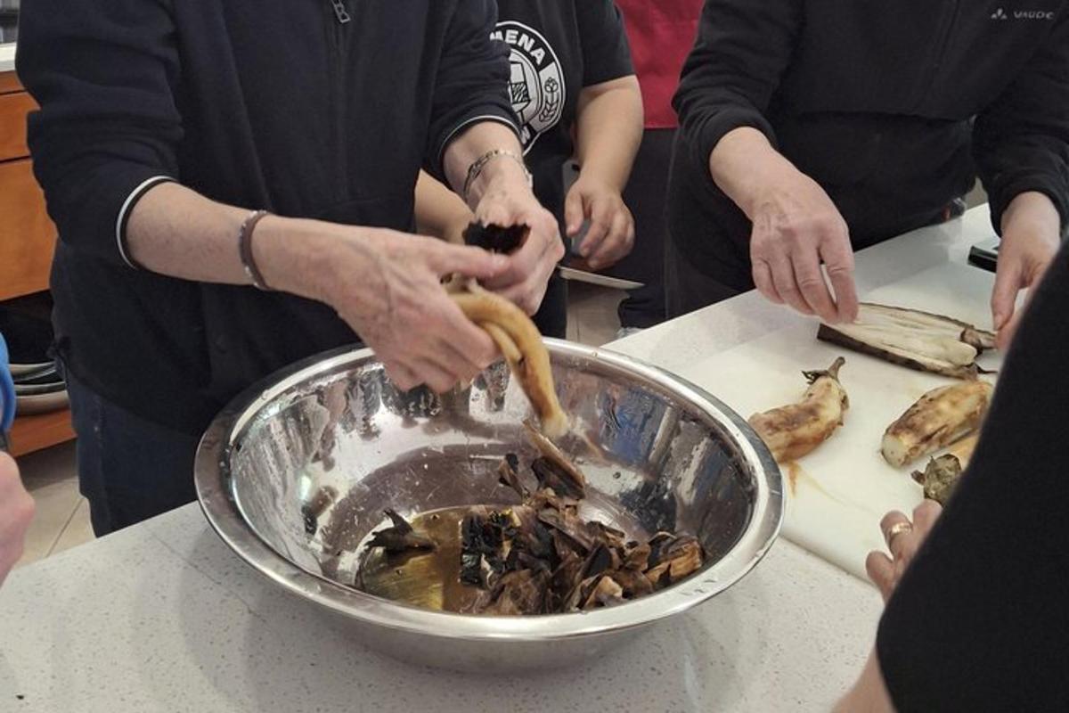 a group of people preparing food in a bowl on a counter