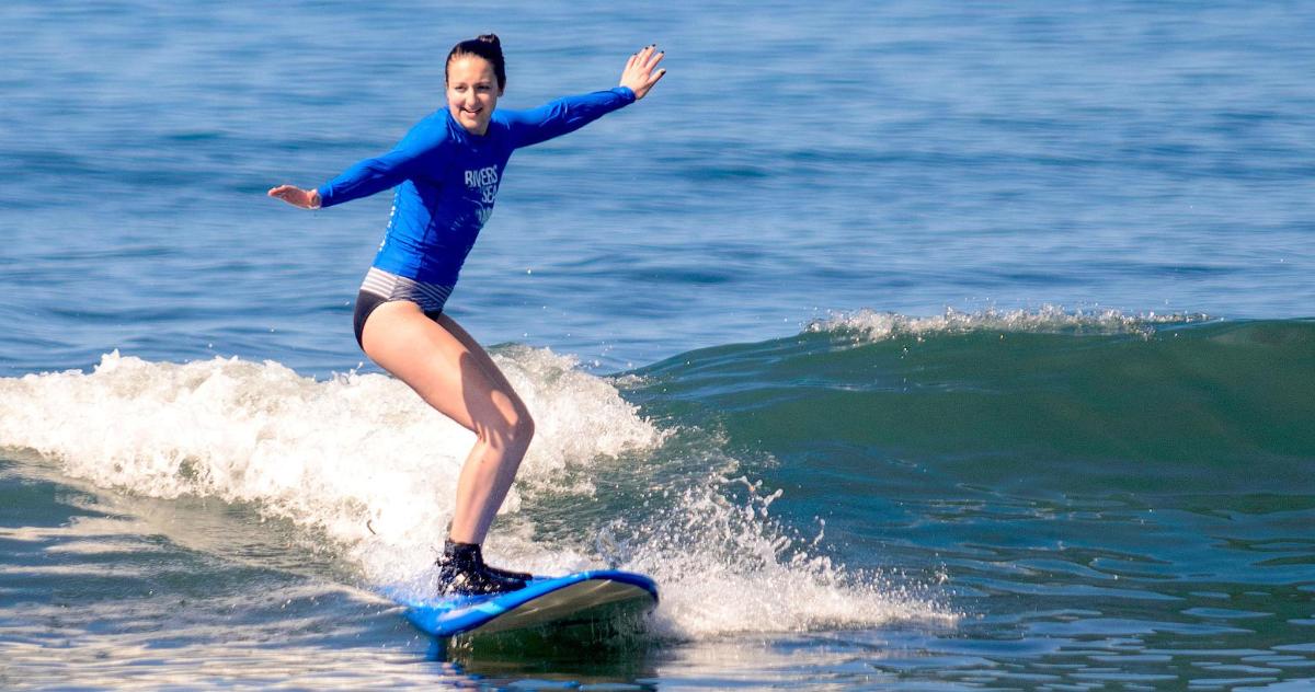 a woman riding a wave on a surfboard in the ocean